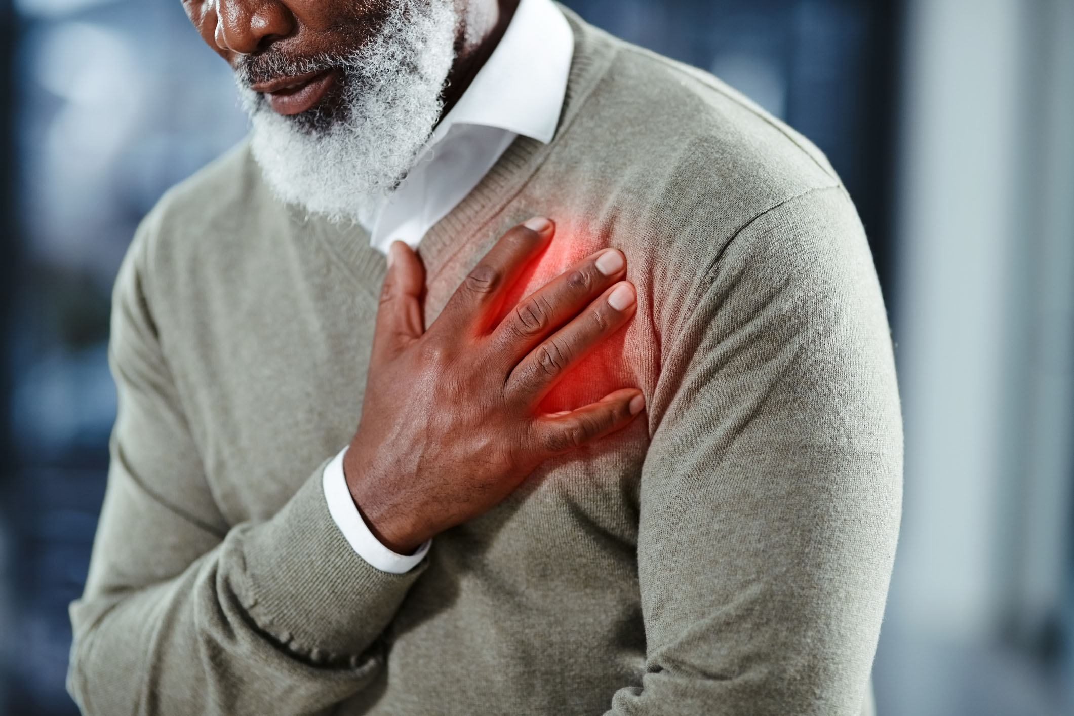 Man with his hand over his heart in pain