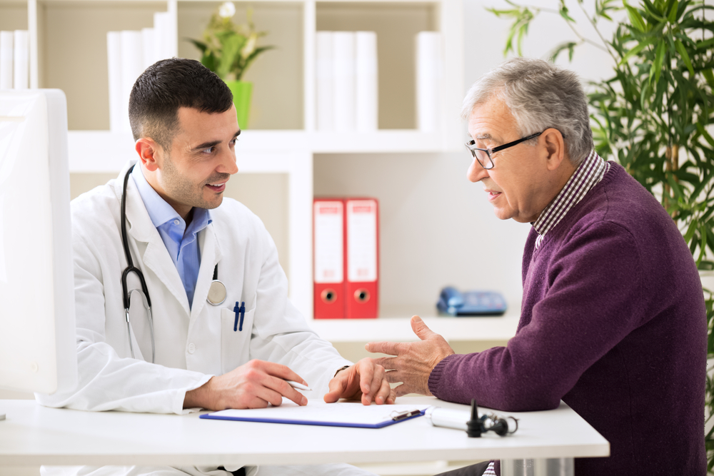 Doctor talking with an older male patient.