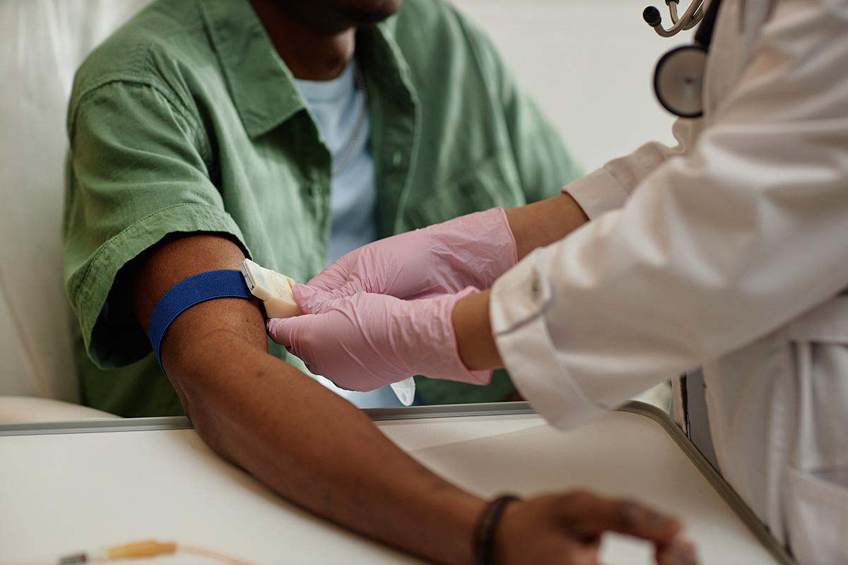 Nurse preparing patient's arm for blood test.