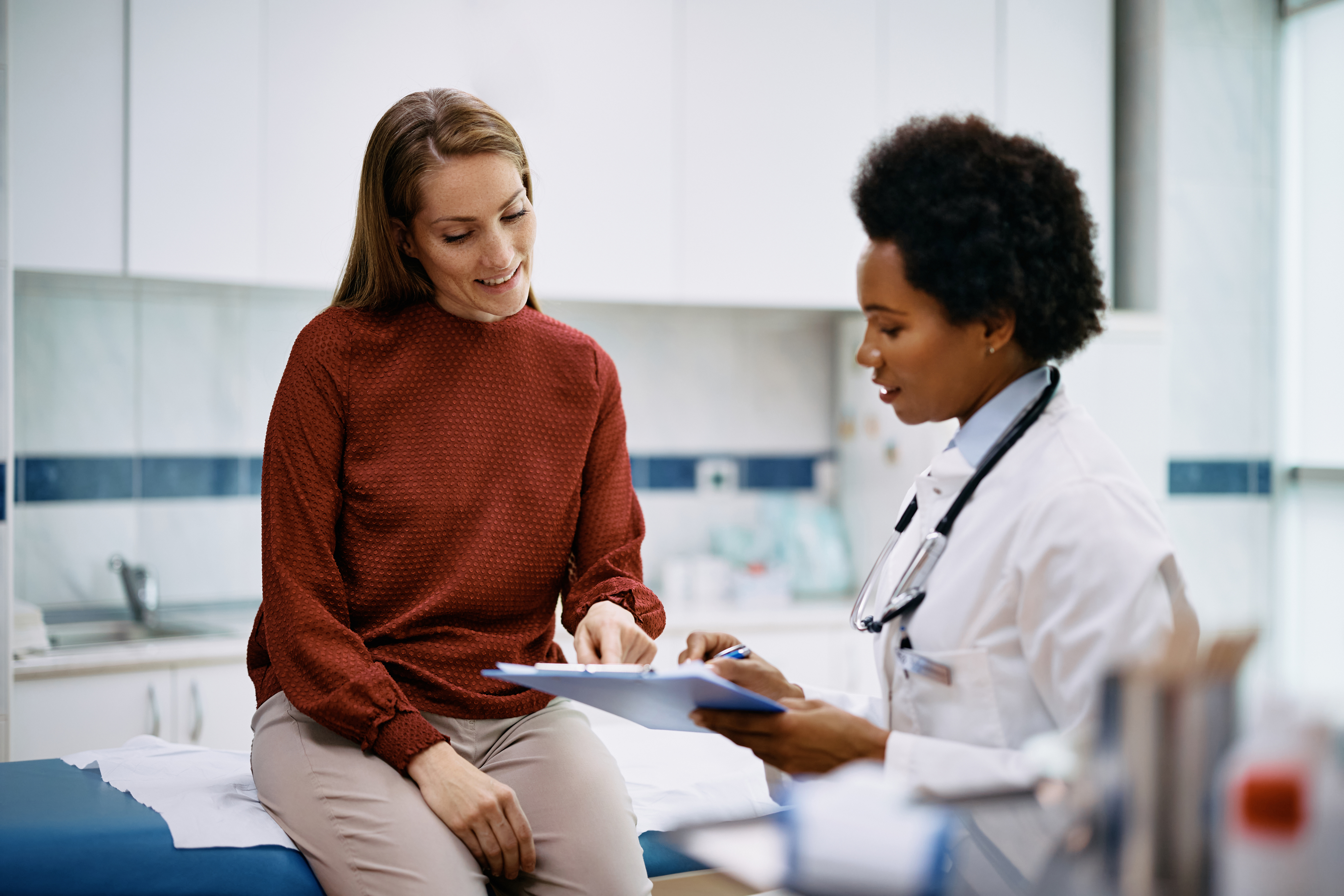 Female patient talking with female doctor.