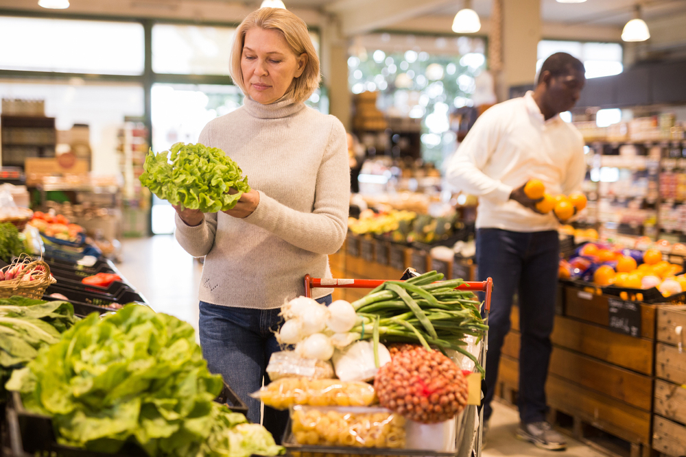Middle-aged woman shopping for fresh vegetables Middle-aged woman shopping for fresh vegetables.