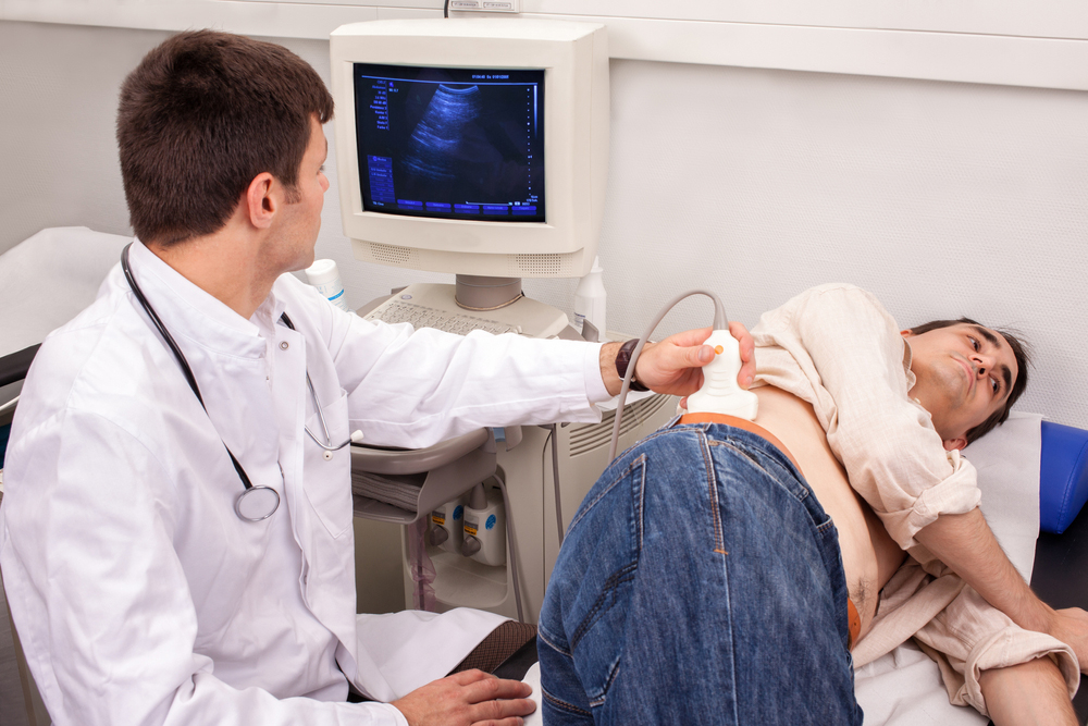 Doctor performing an ultrasound on a patient.