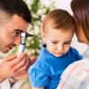 Doctor examining a child’s ear.