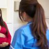 Pregnant woman talking with health care professional Pregnant woman talking with health care professional