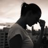 Silhouette of a woman resting her head in her hands Silhouette of a woman resting her head in her hands