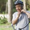 Older man buckling his bike helmet Older man buckling his bike helmet