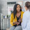 Woman describing her symptoms to a doctor Woman describing her symptoms to a doctor