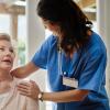 Health care provider smiling while talking to older adult Health care provider smiling while talking to older adult