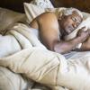 Older African American man asleep bed Older African American man asleep bed