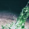 Green wine bottle hitting the floor and breaking Green wine bottle hitting the floor and breaking