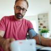 Man checking his blood pressure at home