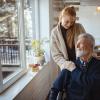Young woman helping her older father