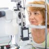 Older woman getting her eyes checked at the eye doctor Older woman getting her eyes checked at the eye doctor