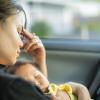 Stressed mom trying to nap with her baby in the car Stressed mom trying to nap with her baby in the car