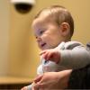 Smiling toddler looking at person on tablet screen Smiling toddler looking at person on tablet screen