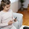 Young girl checking her blood sugar levels Young girl checking her blood sugar levels
