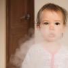 Young girl in a cloud of cigarette smoke Young girl in a cloud of cigarette smoke