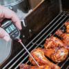 Thermometer showing temperature of chicken that’s being grilled Thermometer showing temperature of chicken that’s being grilled