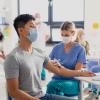 Man with facemask getting vaccinated at a clinic