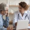 Female doctor talking with older male patient Female doctor talking with older male patient
