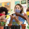 Teacher and students in a classroom and looking seedlings Teacher and students in a classroom and looking seedlings