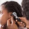 Young girl getting ears checked by her health care provider Young girl getting ears checked by her health care provider