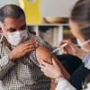 Person wearing a mask getting a COVID-19 vaccine from their health care provider Person wearing a mask getting a COVID-19 vaccine from their health care provider.