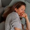 Tired woman laying on the couch.
