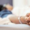A person holding hands with a patient A person holding hands with a patient.