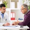 Doctor talking with an older male patient.