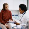 Female patient talking with female doctor.