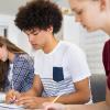 Two high school students doing school work in class.