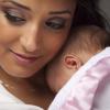 Woman holding a newborn Woman holding a newborn.