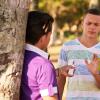 Teenager at the park turning down an e-cigarette.