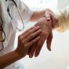 Doctor examining a patient's hand.
