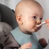 Baby being spoon-fed solid foods.