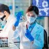 Scientists looking at blood samples in a lab. 