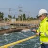 Environmental engineer taking notes at a wastewater treatment plant. 