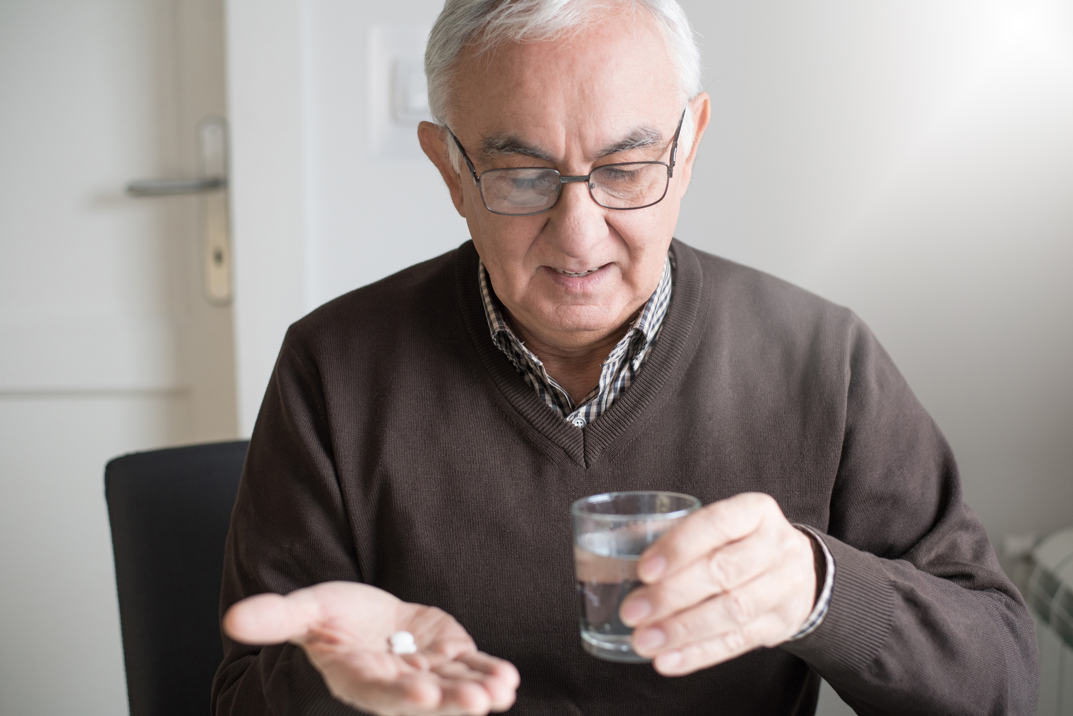 Man holding pill bottle