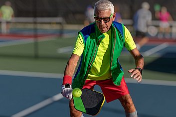 Older man playing pickleball