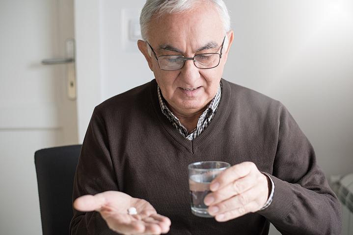 Elderly man with medicine