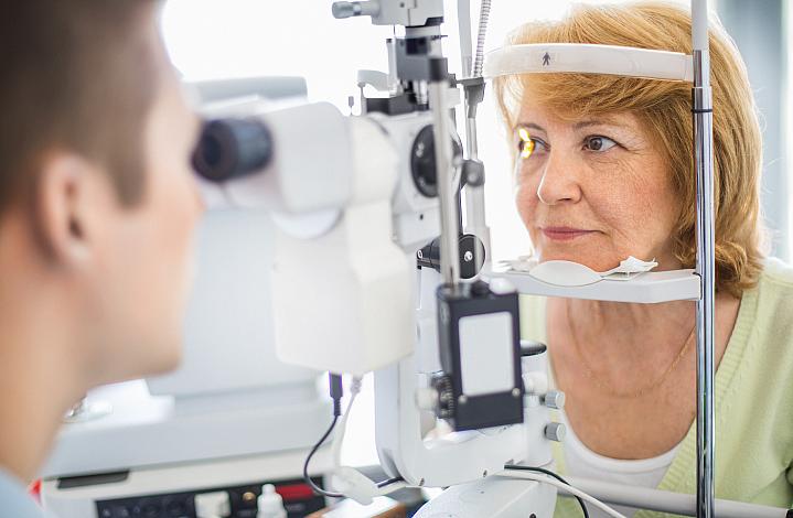 Older woman getting her eyes checked at the eye doctor