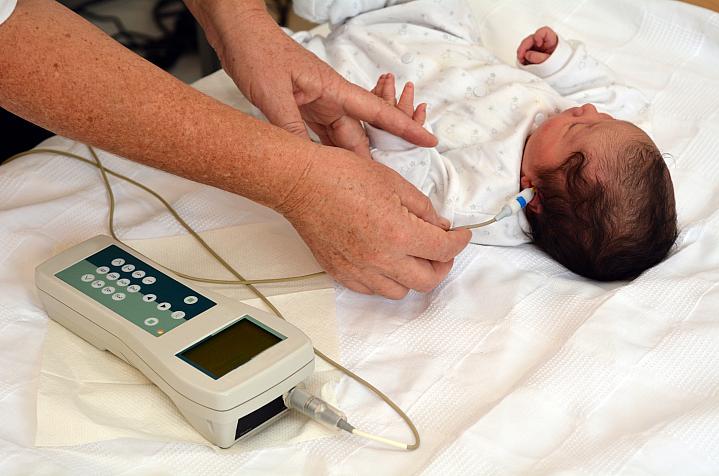 A newborn getting a hearing test