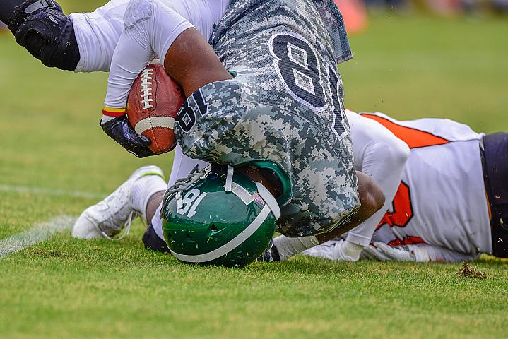 High school football player landing on their head.